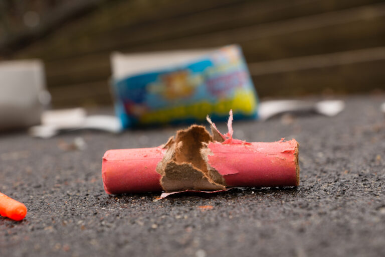 Burnt firecrackers on the street for urgent-care-for-a-firework-injury blog.