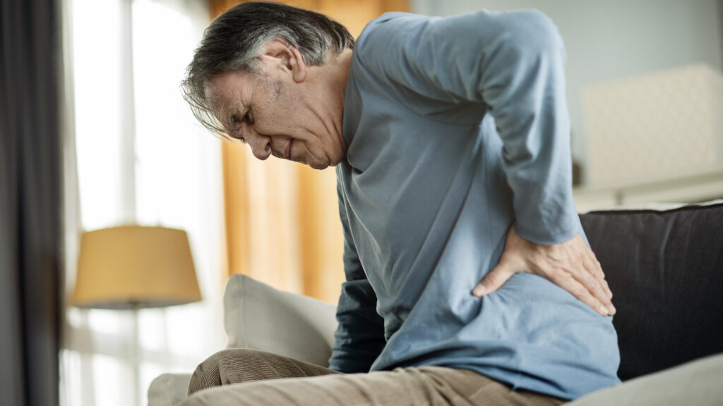 An older man suffers from intense back pain for urgent-care-for-kidney-stones blog.
